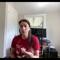 Erika Gardner, a light-skinned woman with long, brown hair, wearing a red t-shirt