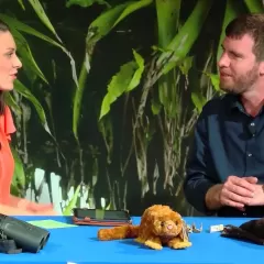 Maggy Benson and Dr. Kristofer Helgan are seated at a table with several furry specimens in front of them.