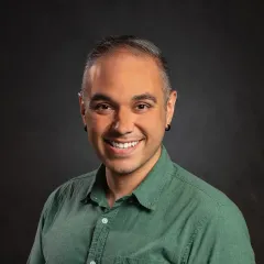 image of man with short dark hair in green shirt