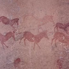 A prehistoric, reddish-brown painting of animals on a rock shelter in Mashonaland, Zimbabwe