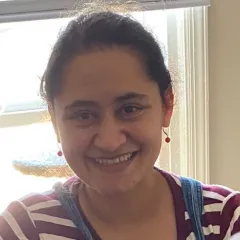 image of latina woman with dark hair wearing a red and white striped shirt