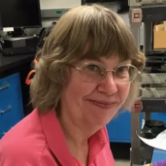 A woman smiling in a laboratory