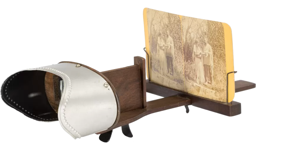 a wooden photograph view finder with an old photo in grasp