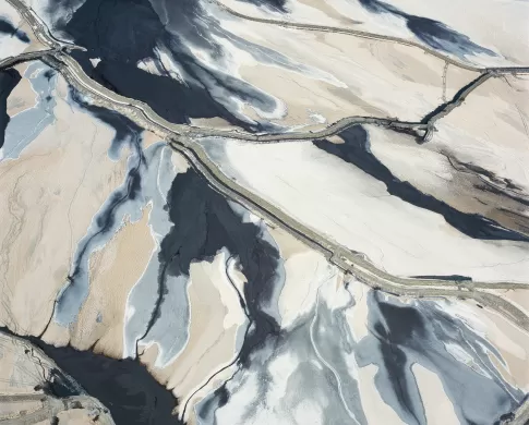 aerial view of gray tone copper mine with tracks showing 