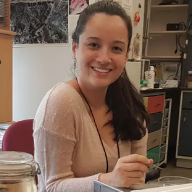 A woman smiling at her desk