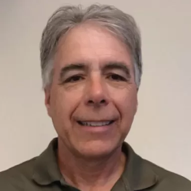 A man smiling for a portrait photo