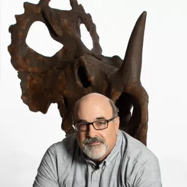 Image of Steve Jabo in front of a Ceratopsian skull