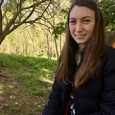 A portrait of Julia Steier with trees in the background. 