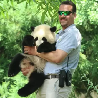 Juan Rodriguez holding a Giant panda.