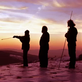 Dennis Stanford and other anthropologists practicing the use of atlatls in the sunset