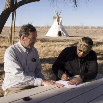 Otto Braided Hair signing documents, with Bill Billeck