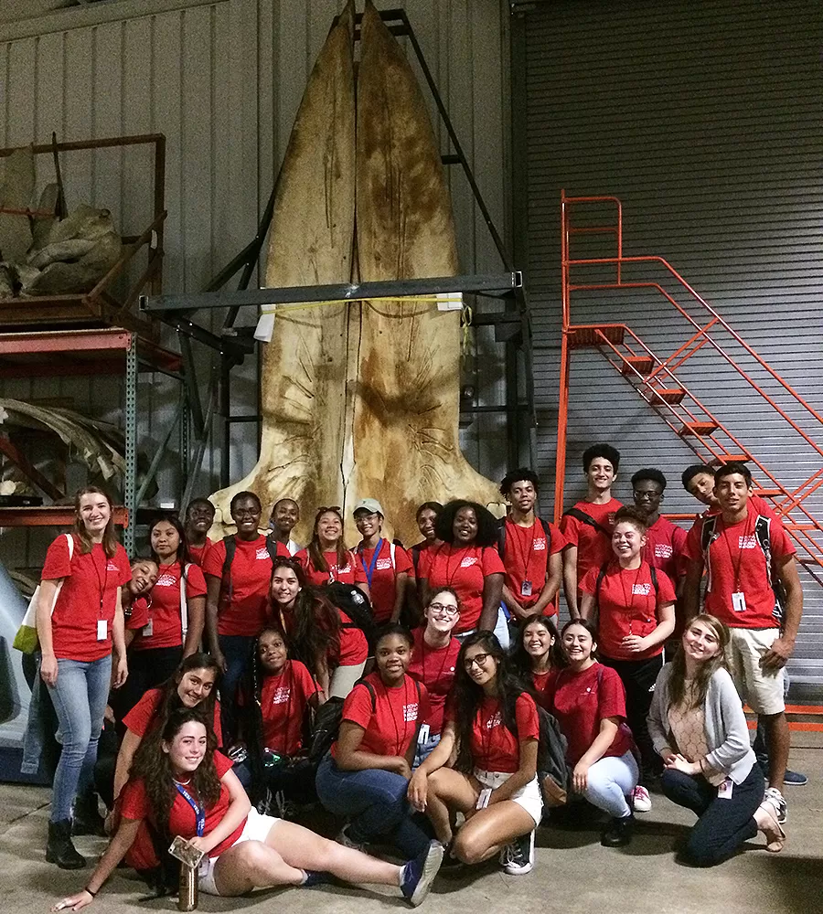 The 2018 group of 25 YES teen interns pose in their red intern shirts.